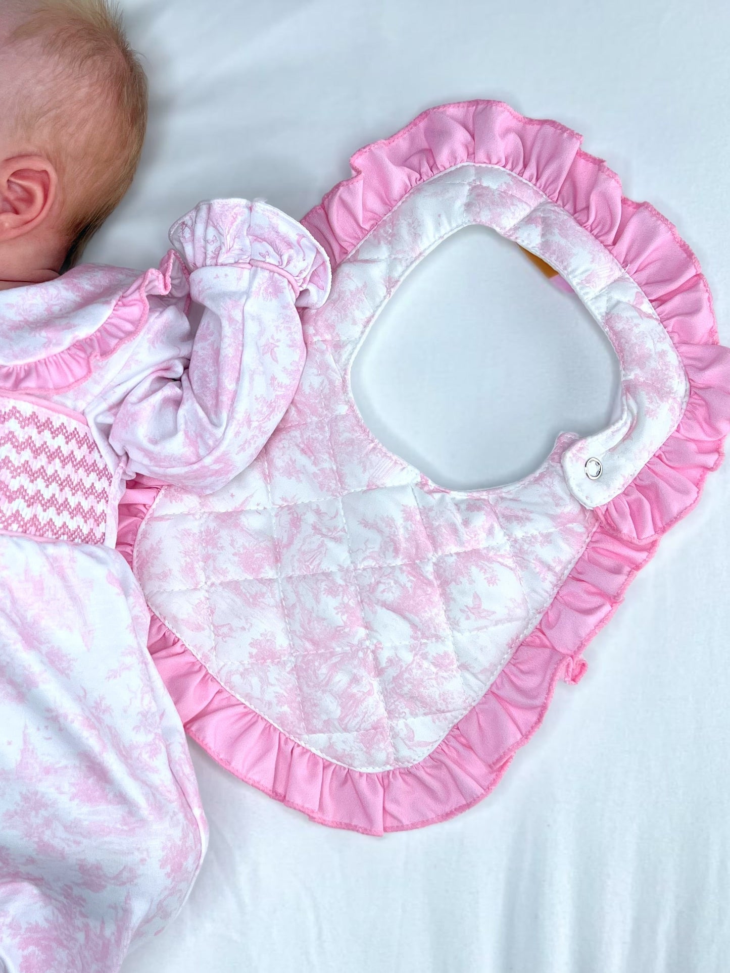 Pink toile quilted bib